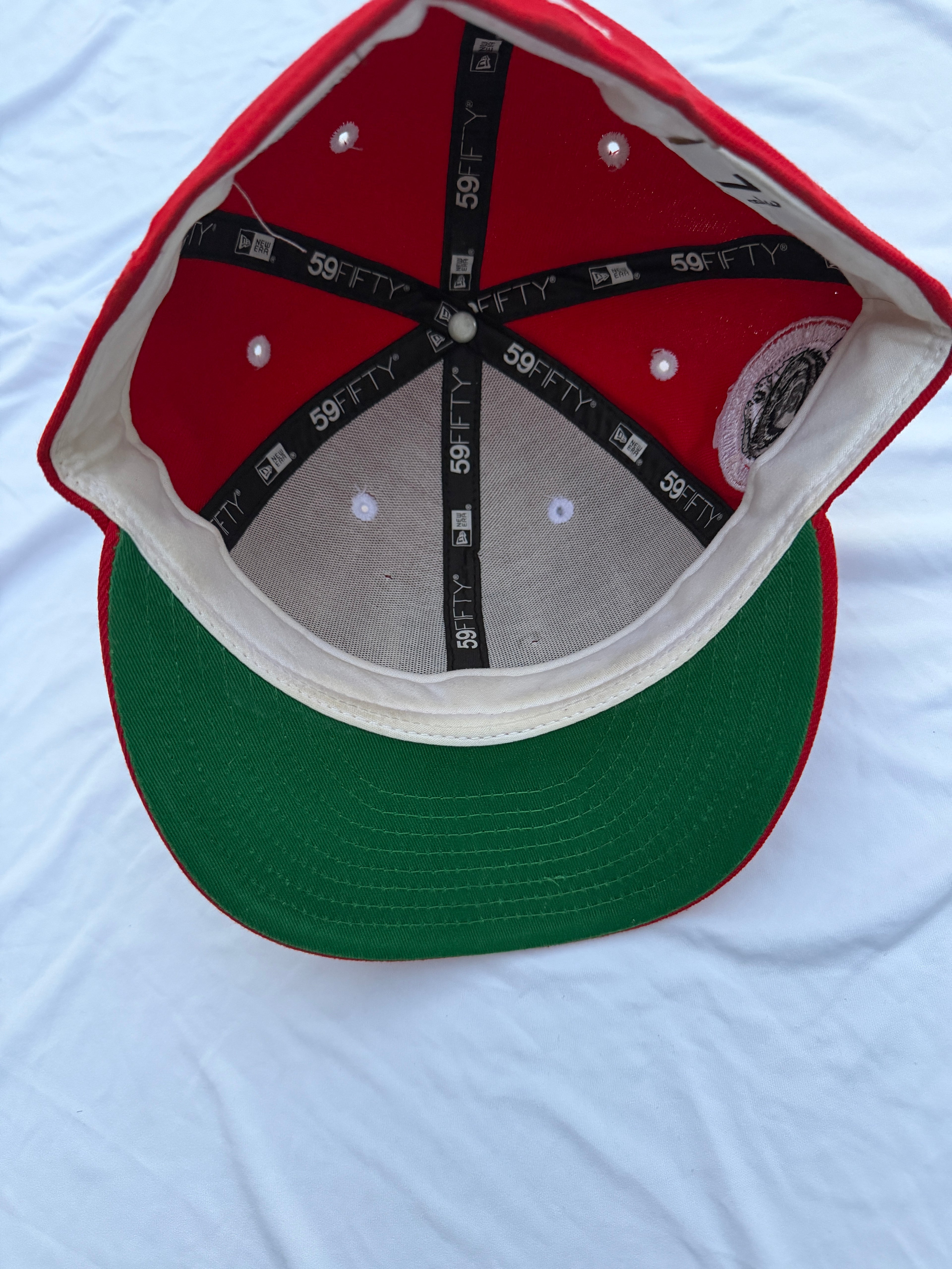 red hat with green under brim 