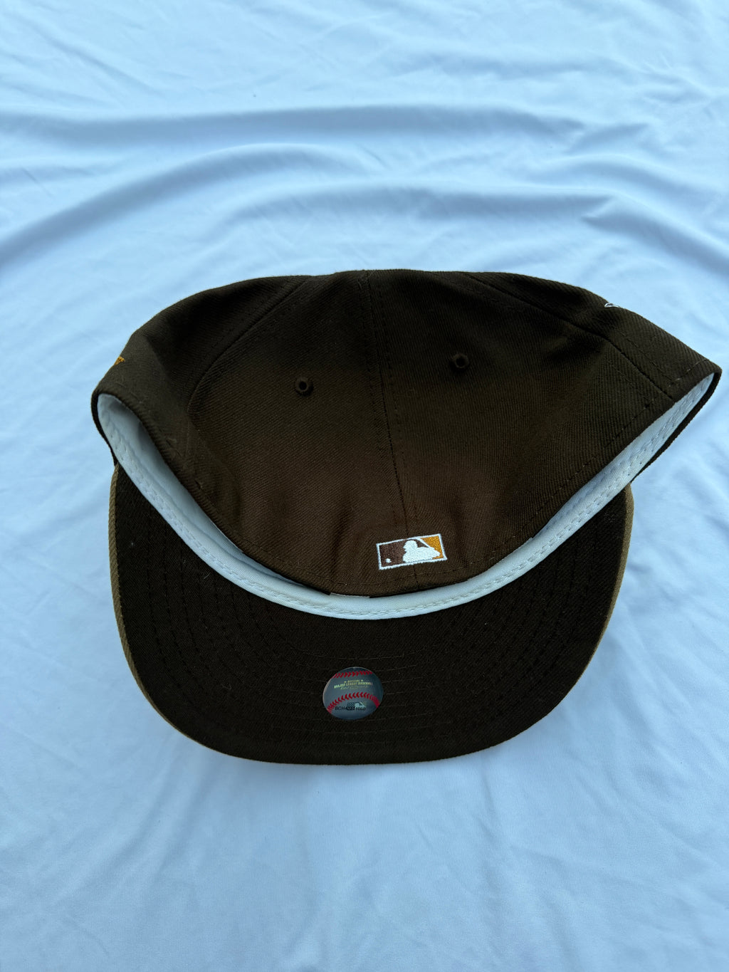 bottom view of cap with dark brown underneath brim