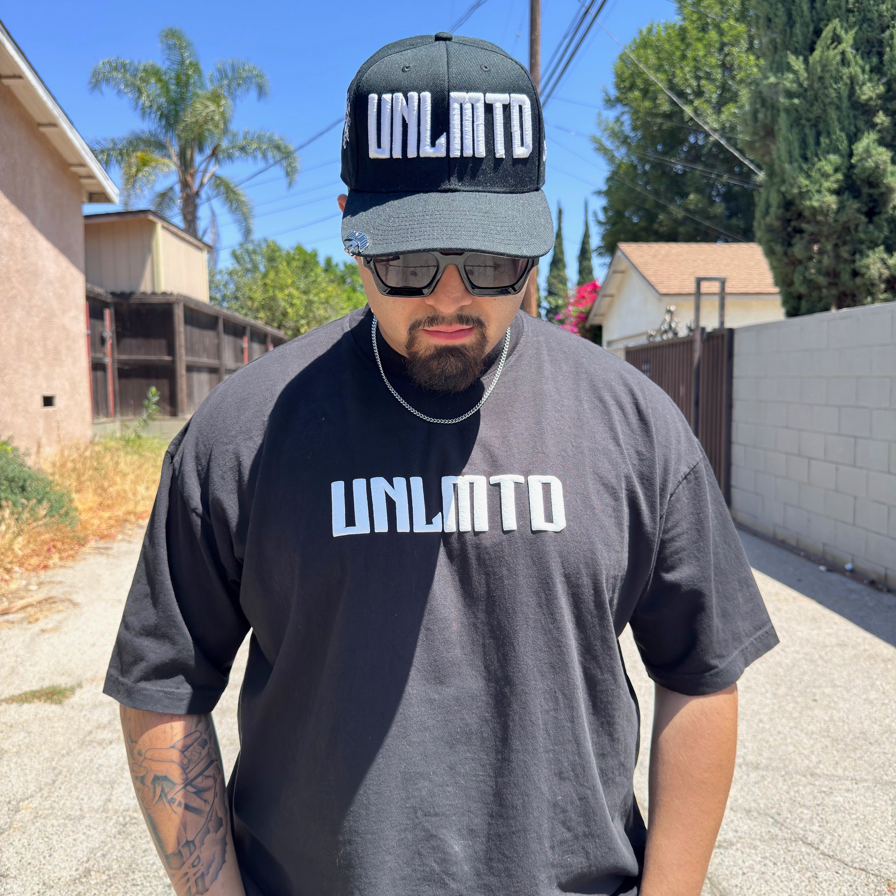 Male modeling black shirt with matching hat 