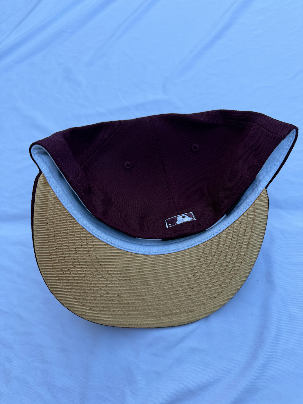 Bottom view of hat, beige under brim 
