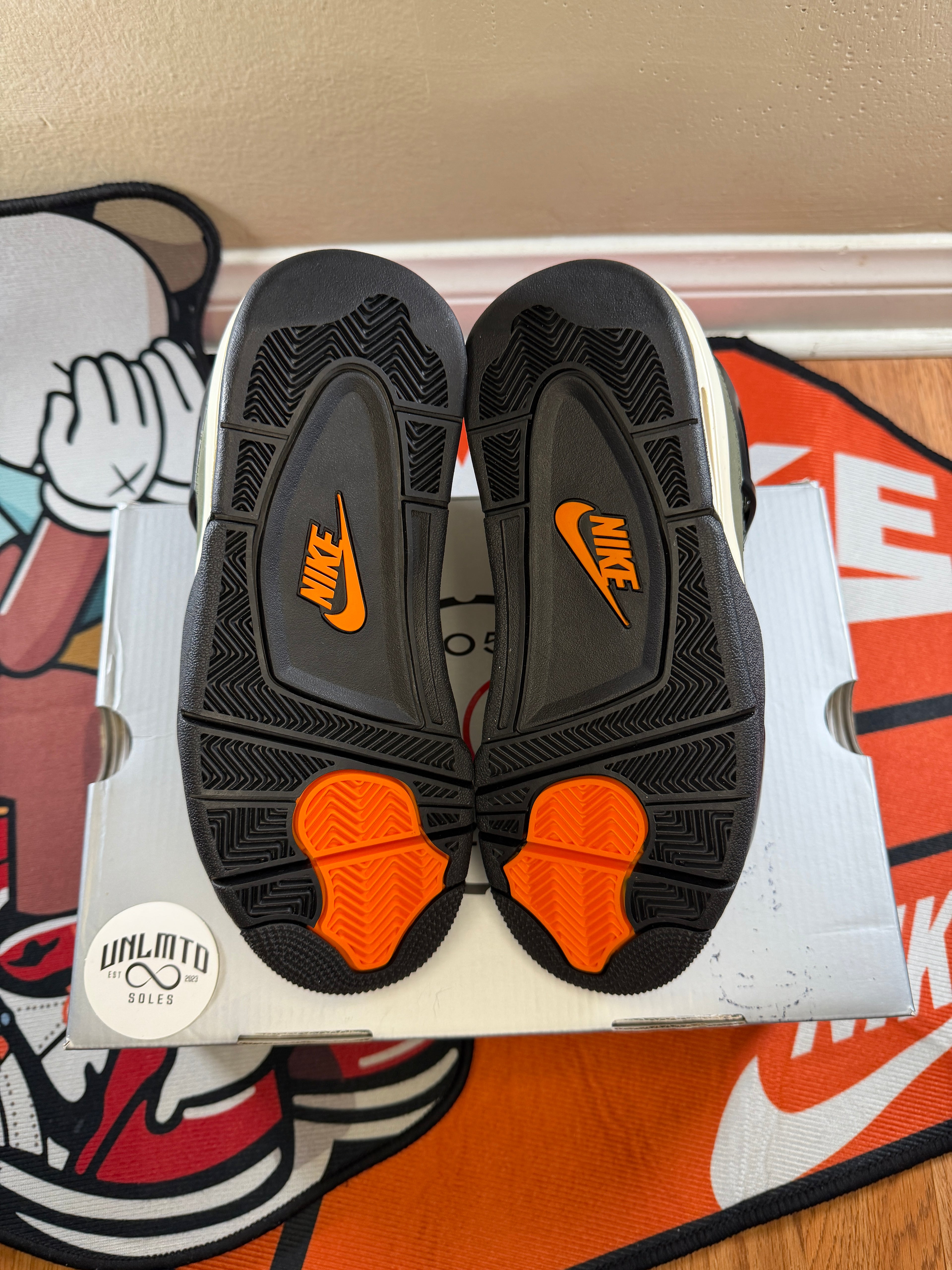 Air Jordan 4 Retro OG 'Undefeated' 2025 sneakers in green and black bottom of shoe with hint of orange