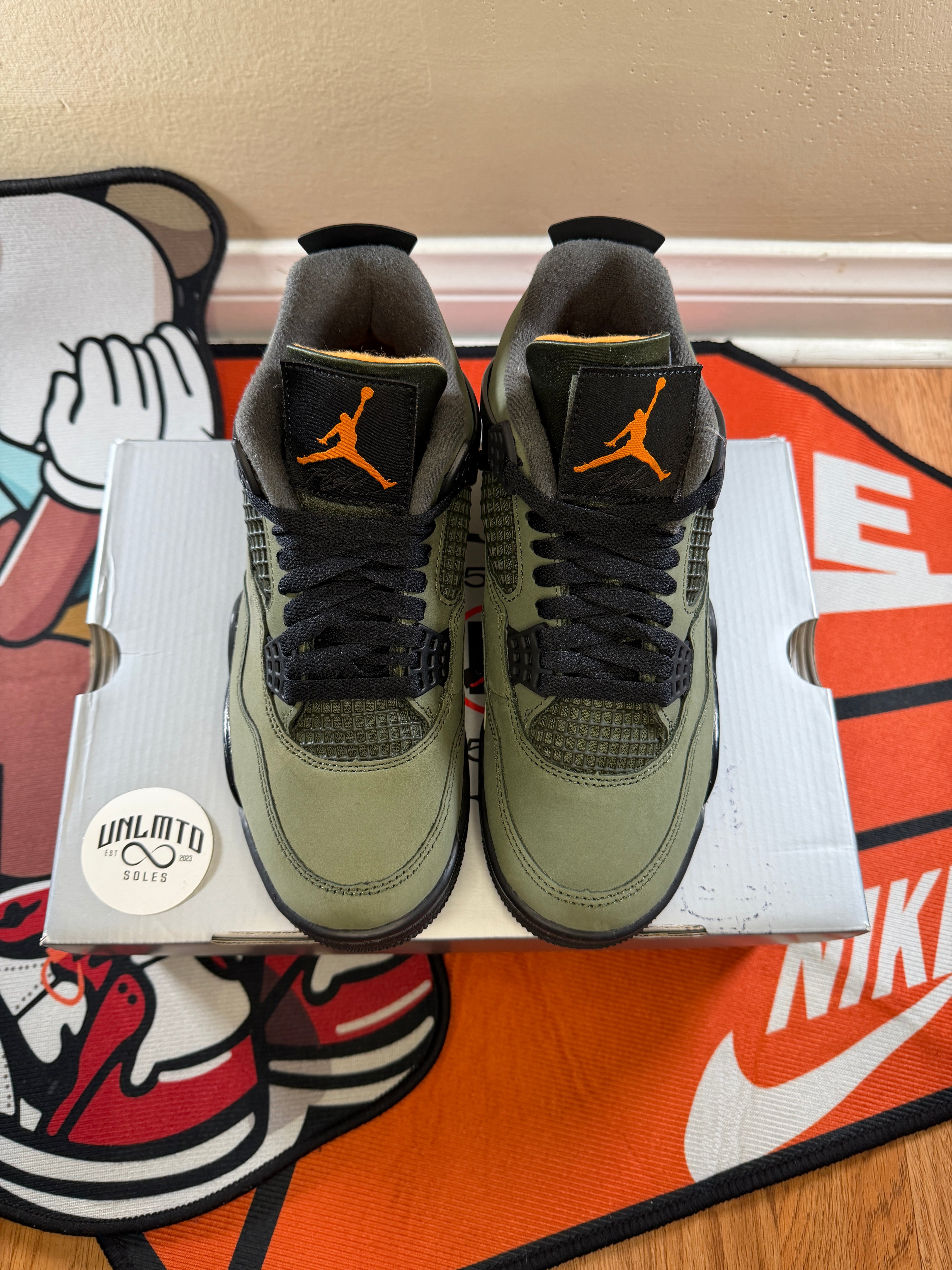Air Jordan 4 Retro OG 'Undefeated' 2025 sneakers in green and black and orange Jordan logo on tongue top view