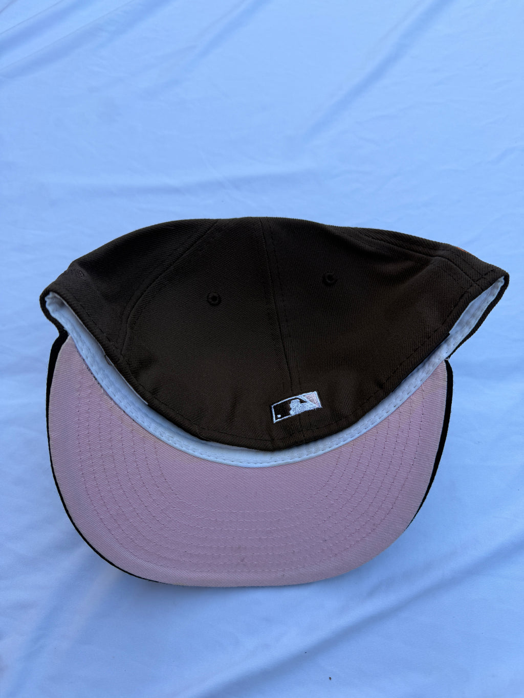 Bottom view of hat, pink under brim 