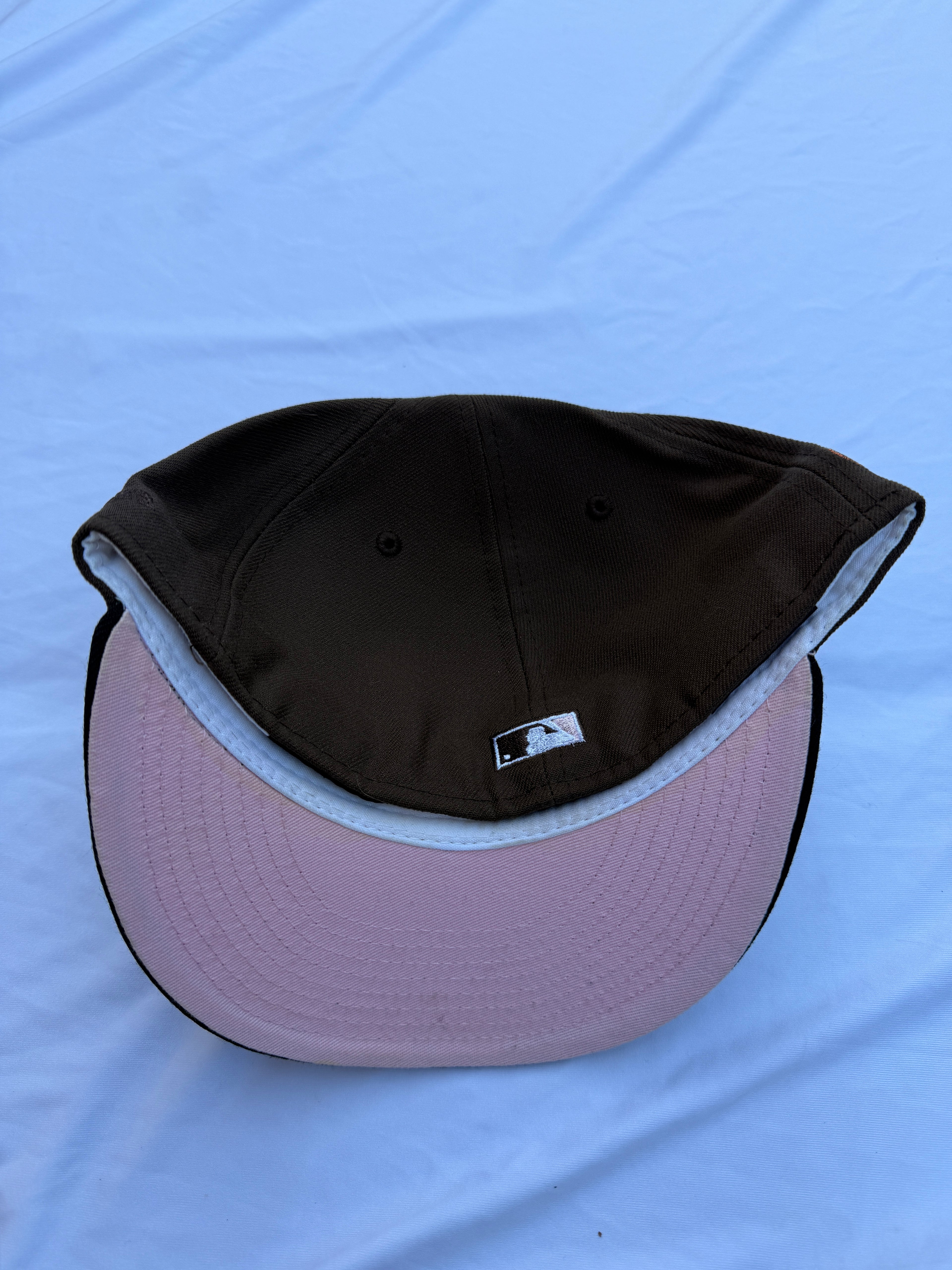 Bottom view of hat, pink under brim 