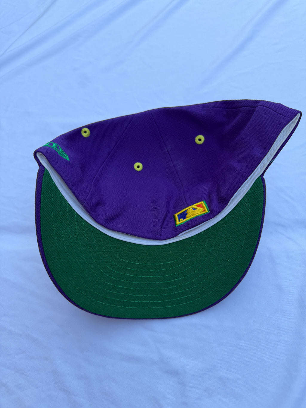 Purple hat with green under brim 