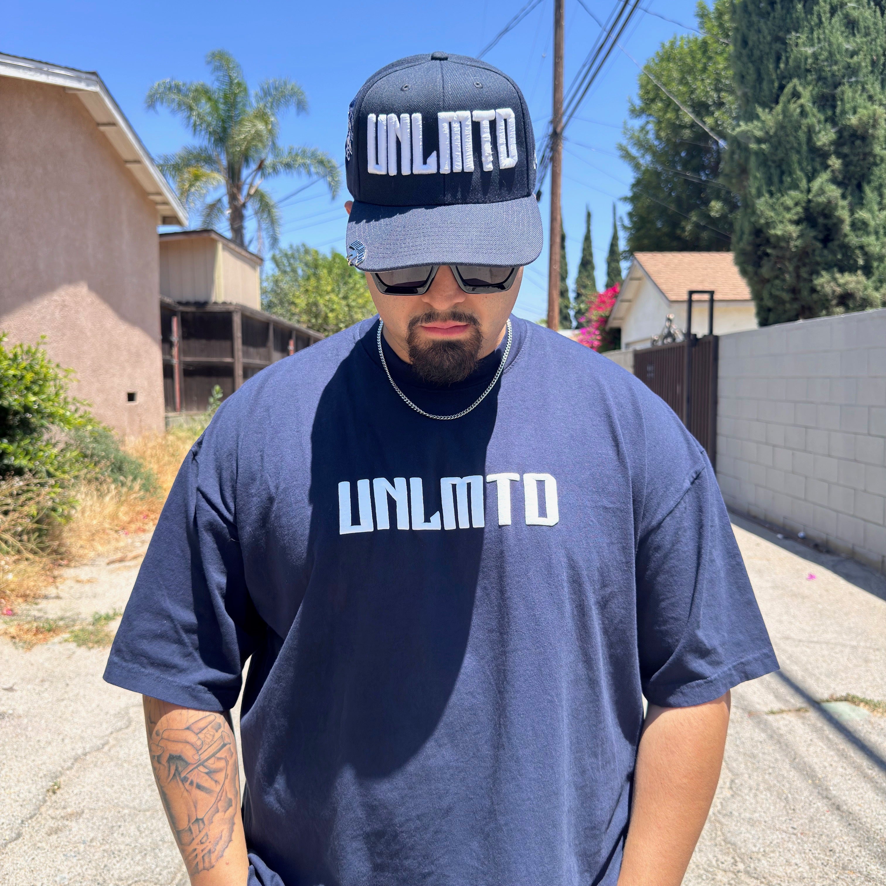 Male modeling navy shirt with matching hat
