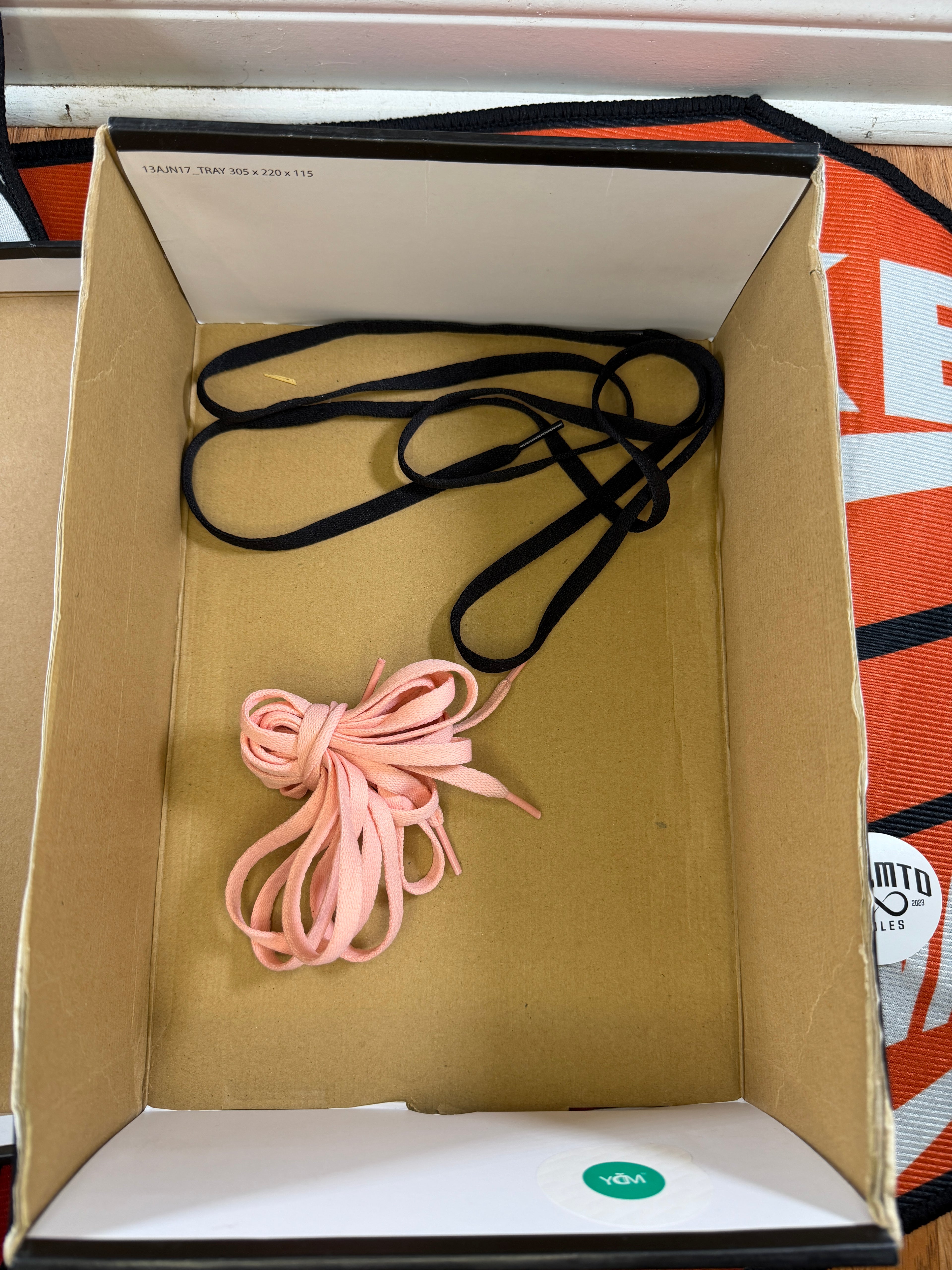 box with black and pink laces inside