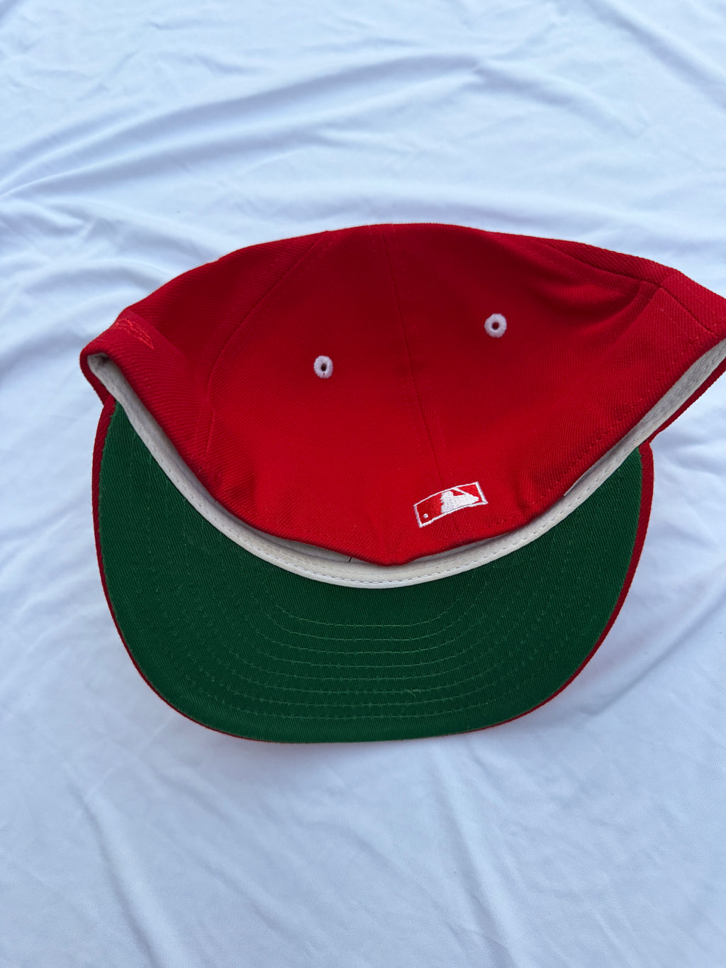 red hat with green under brim