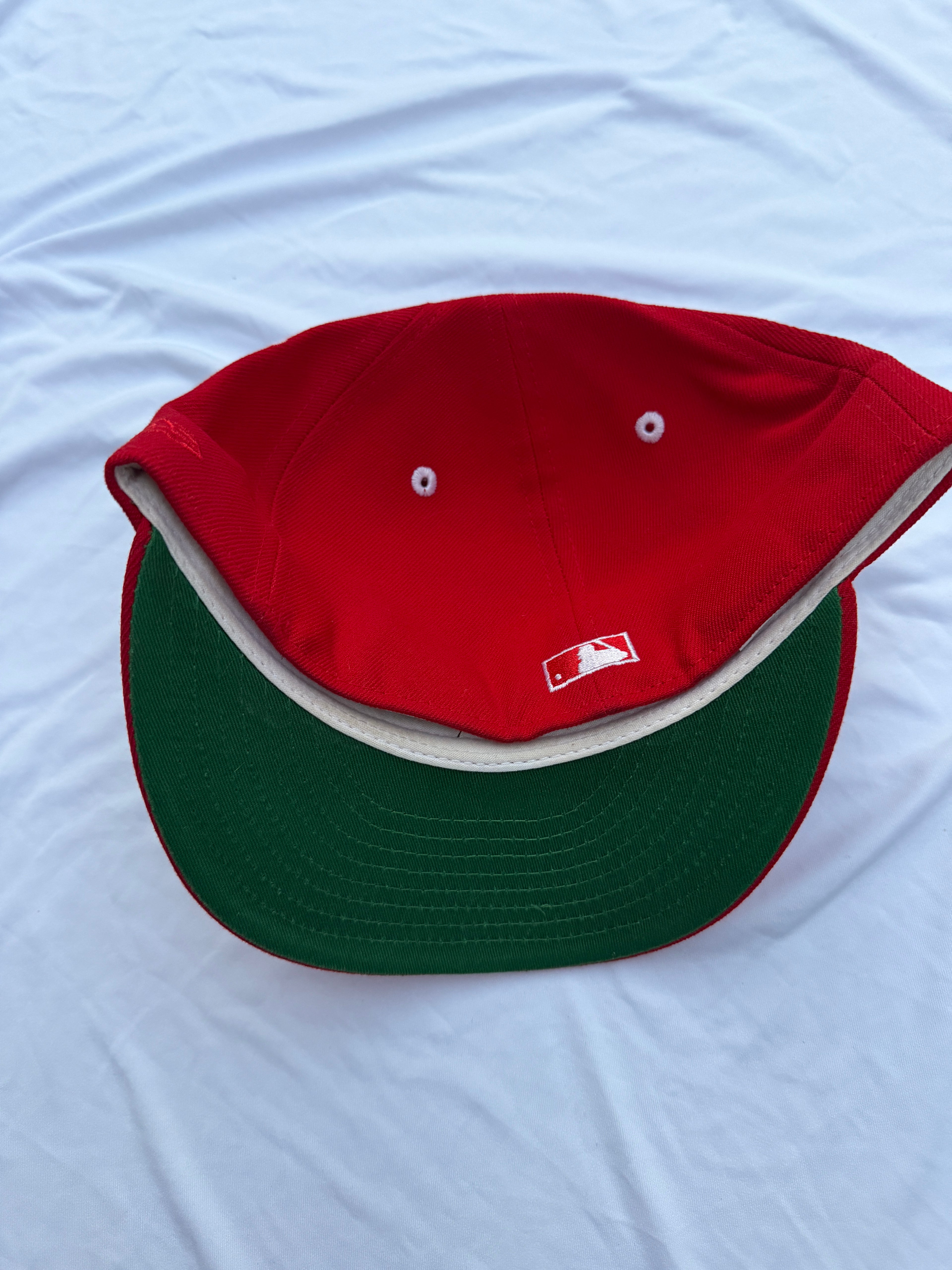 red hat with green under brim