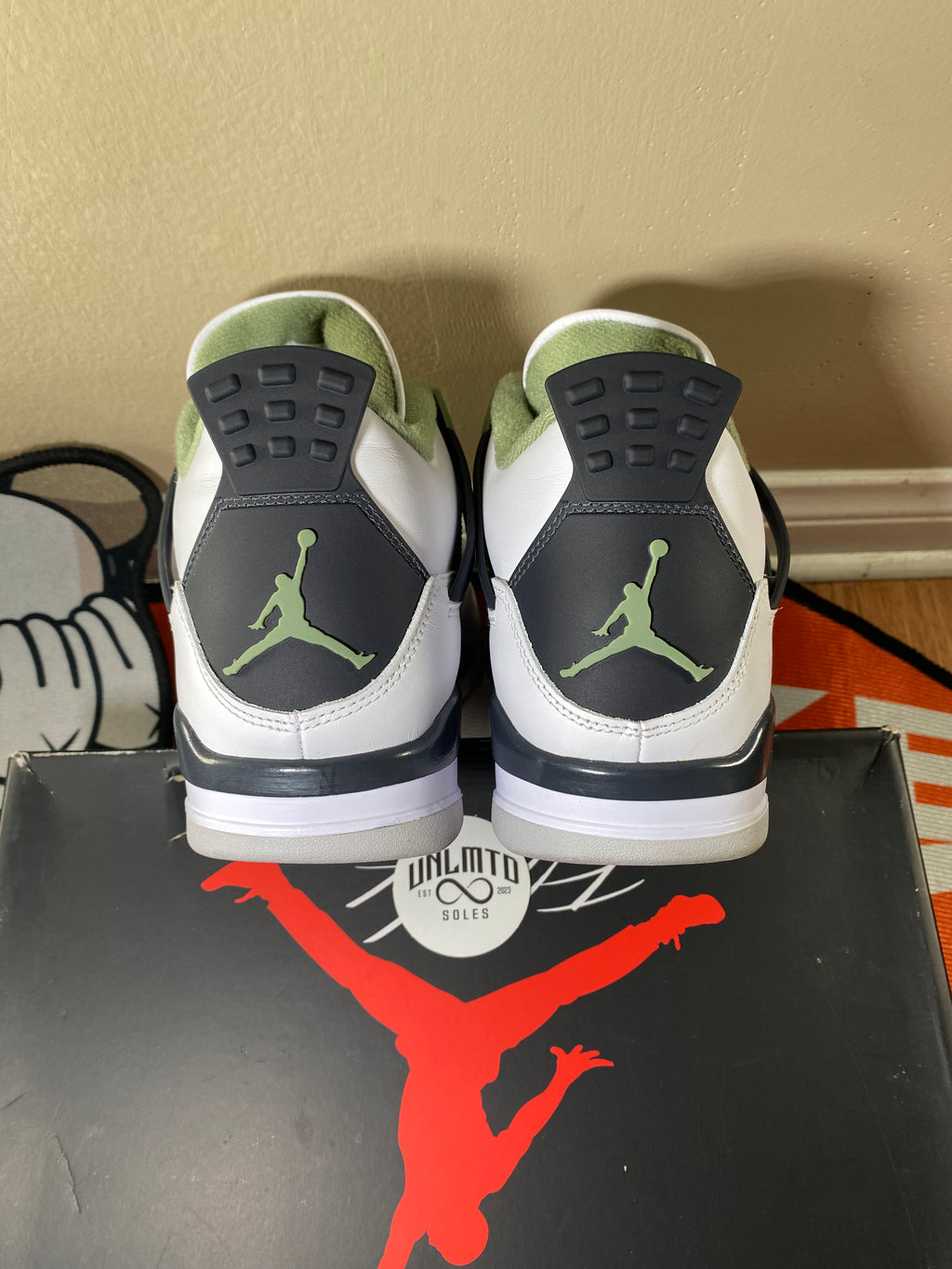 Back of shoes with black and white heel and light green Jordan Jumpman 