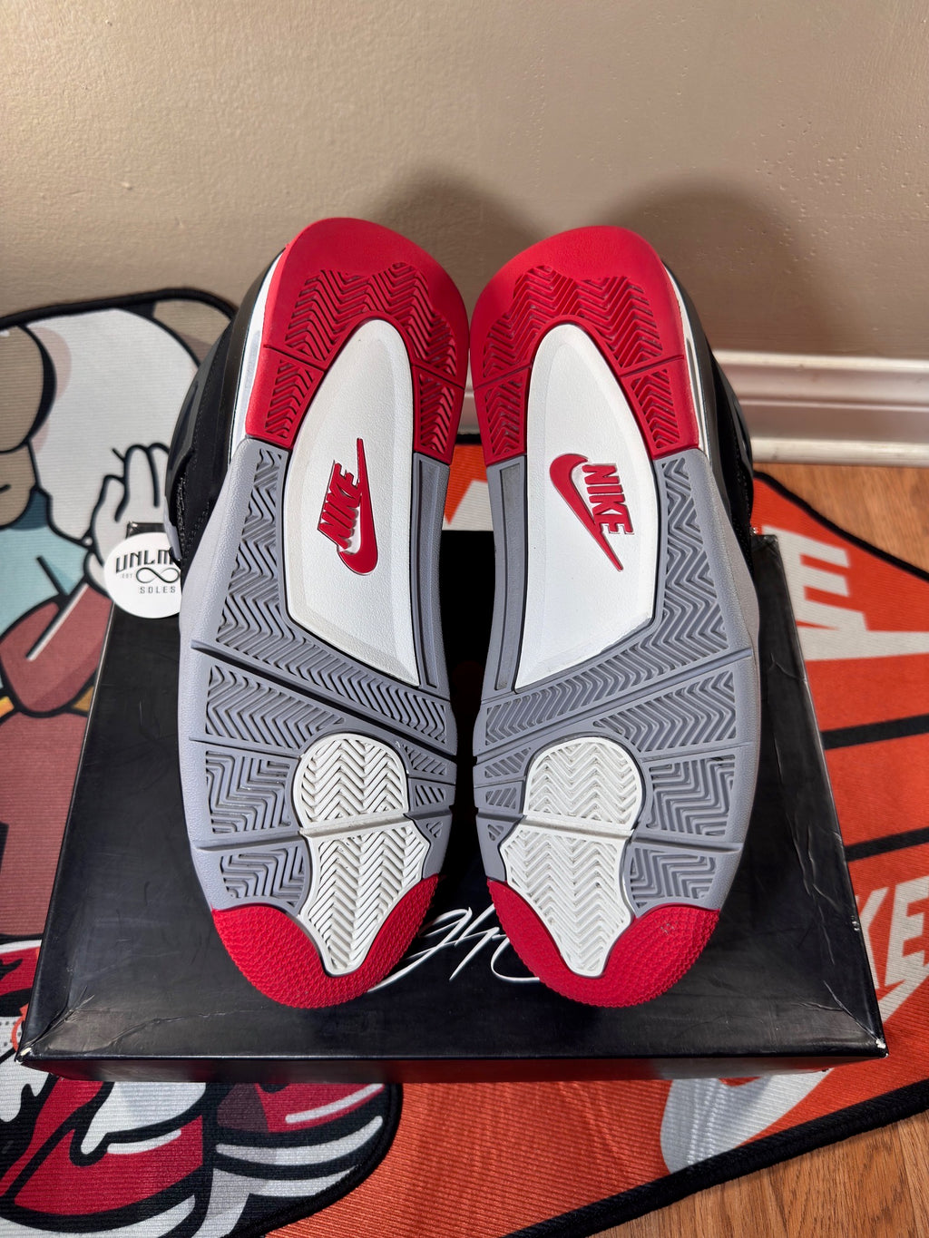 Red grey and white shoe soles, red Nike logo 