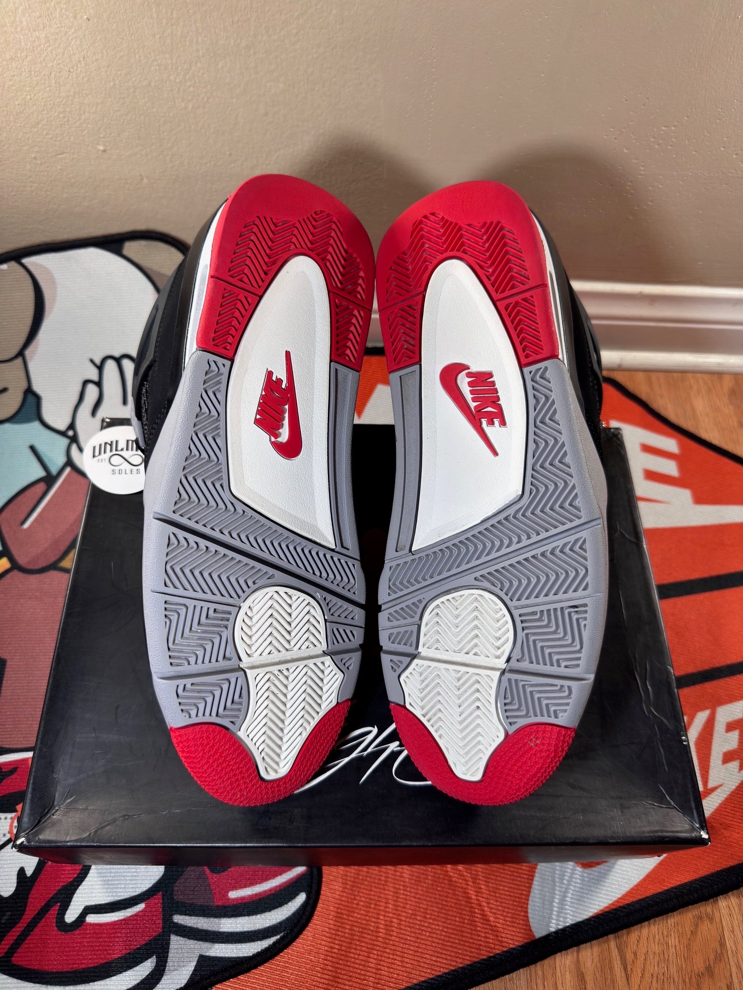 Red grey and white shoe soles, red Nike logo 
