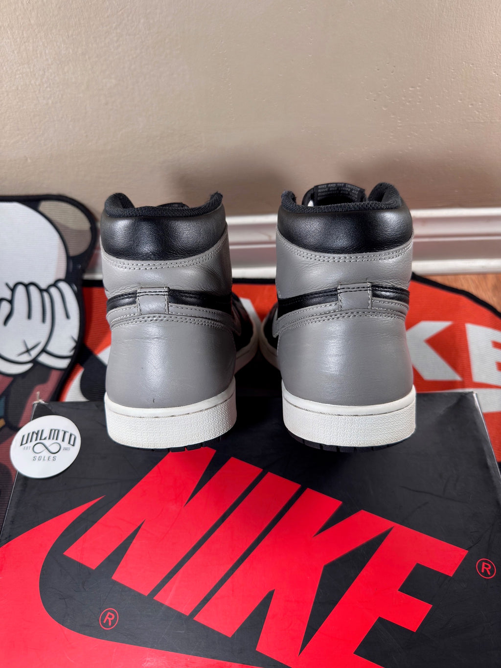 Back of shoe, grey and black with white midsole 