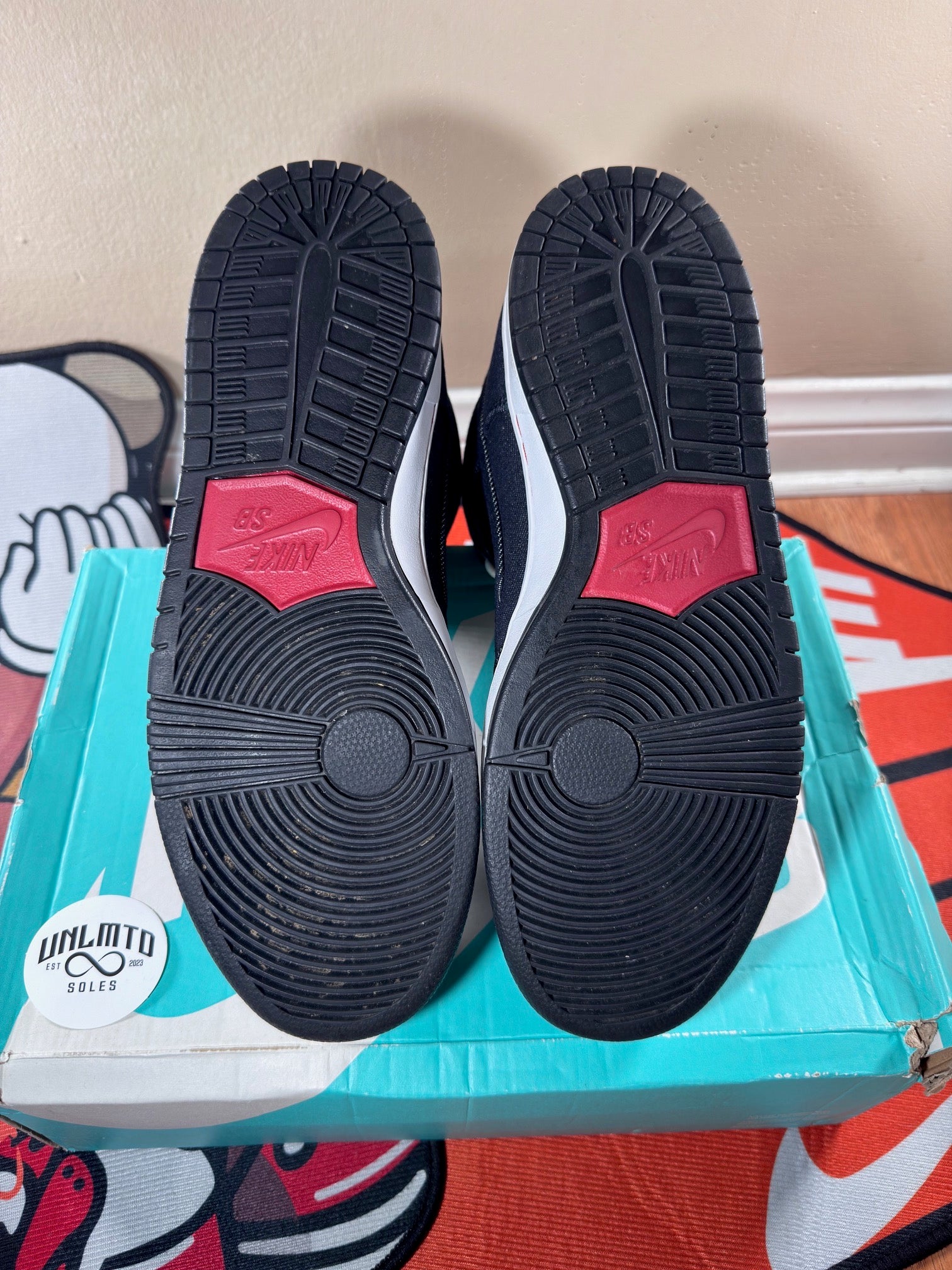 Black soles worn red Nike logo 