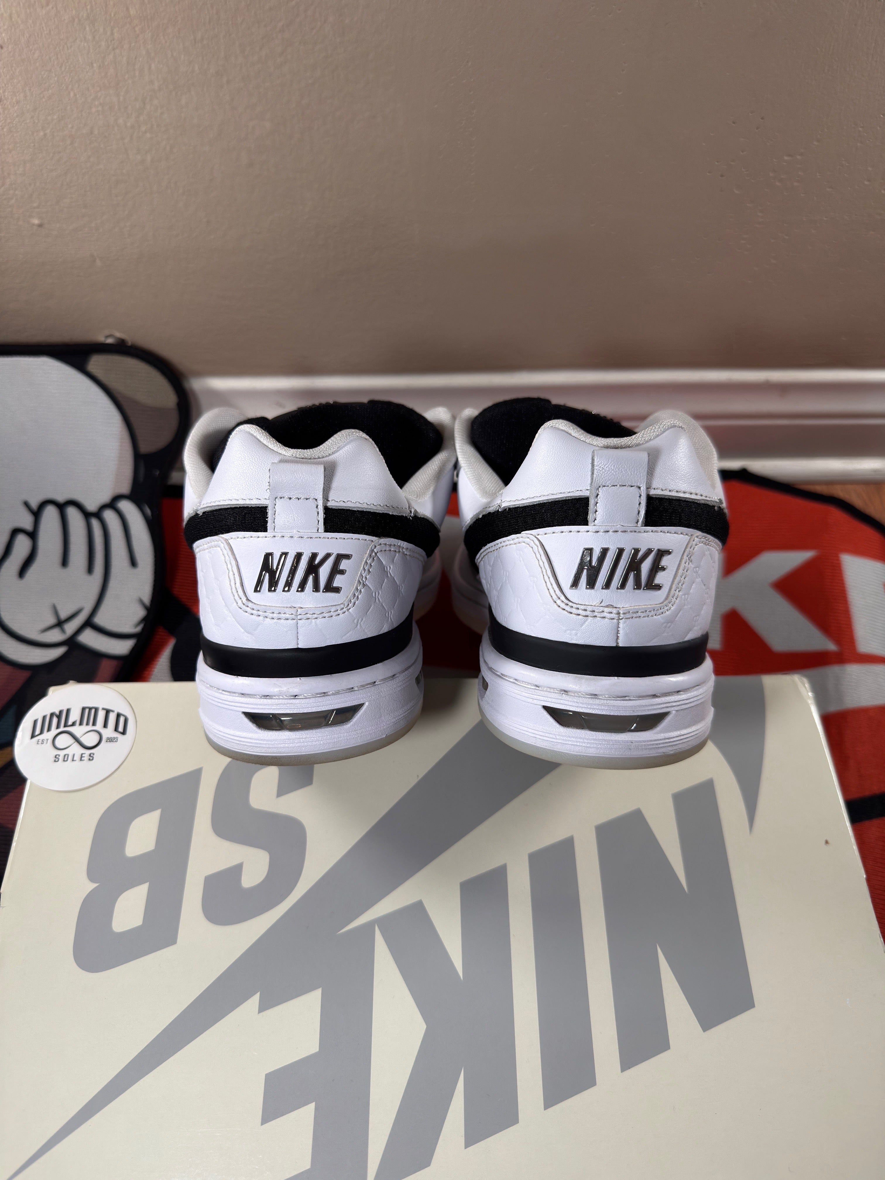 Back of shoe, white with black Nike branding 