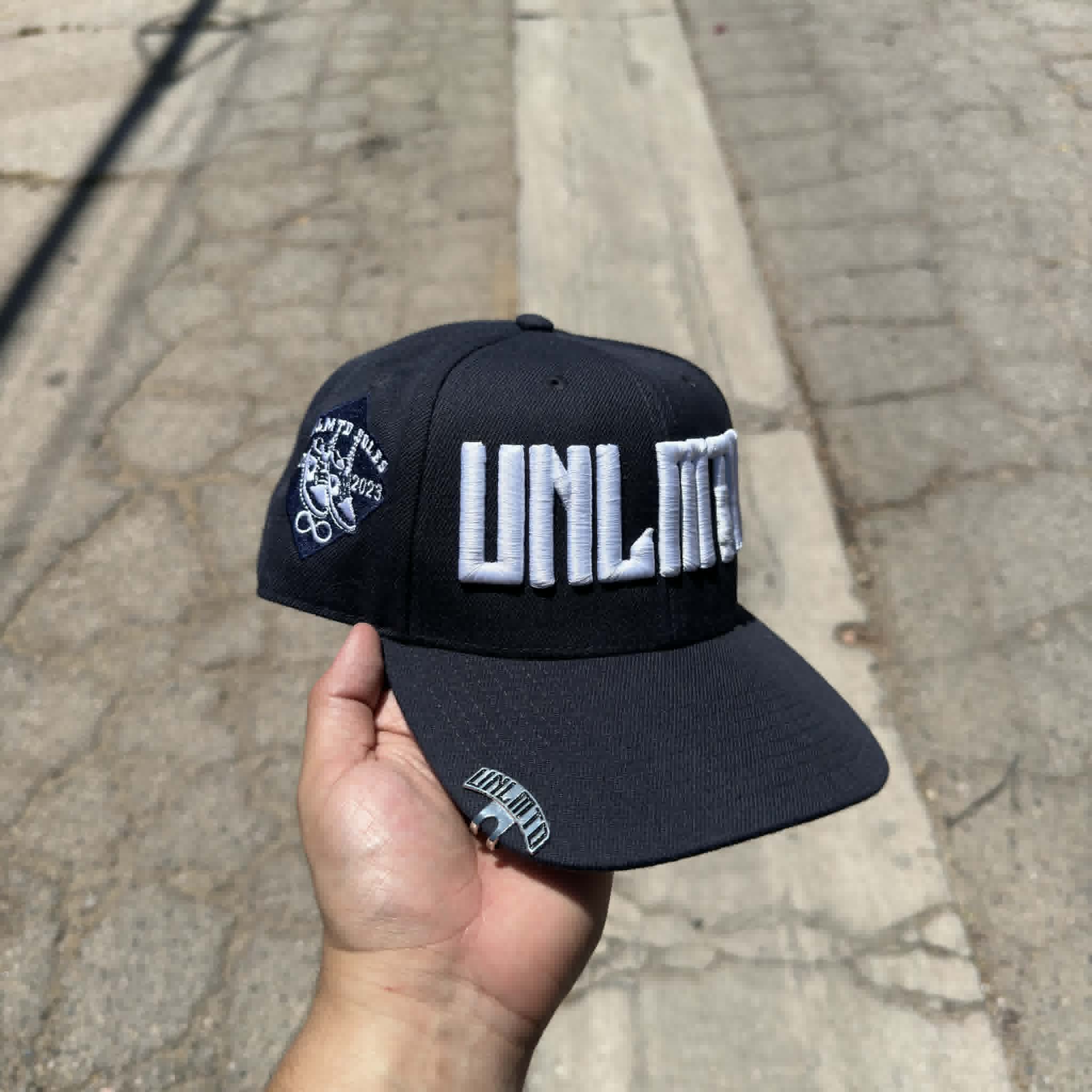 Navy blue cap with white 'UNLMTD' branding